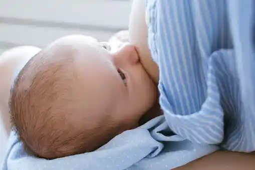 baby enjoying breastfeeding=